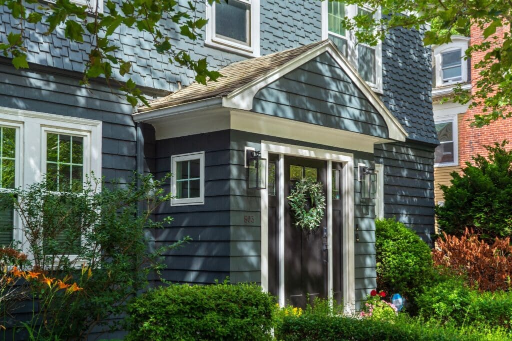 home in massachusetts in the summer with blue siding