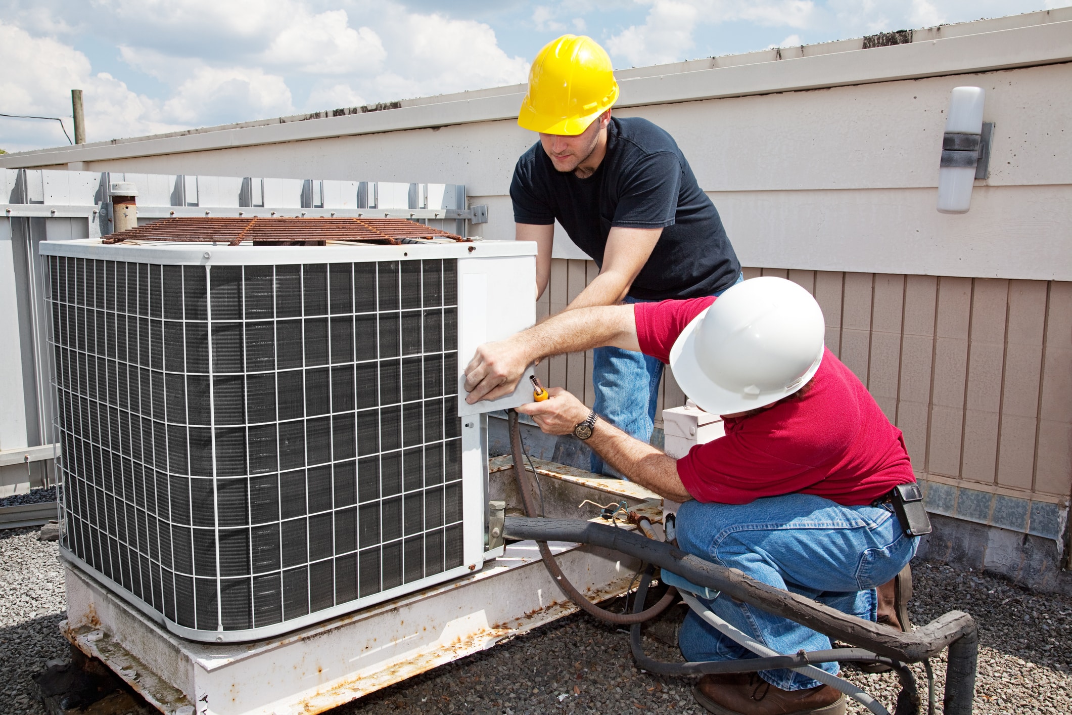 Technicians repairing AC