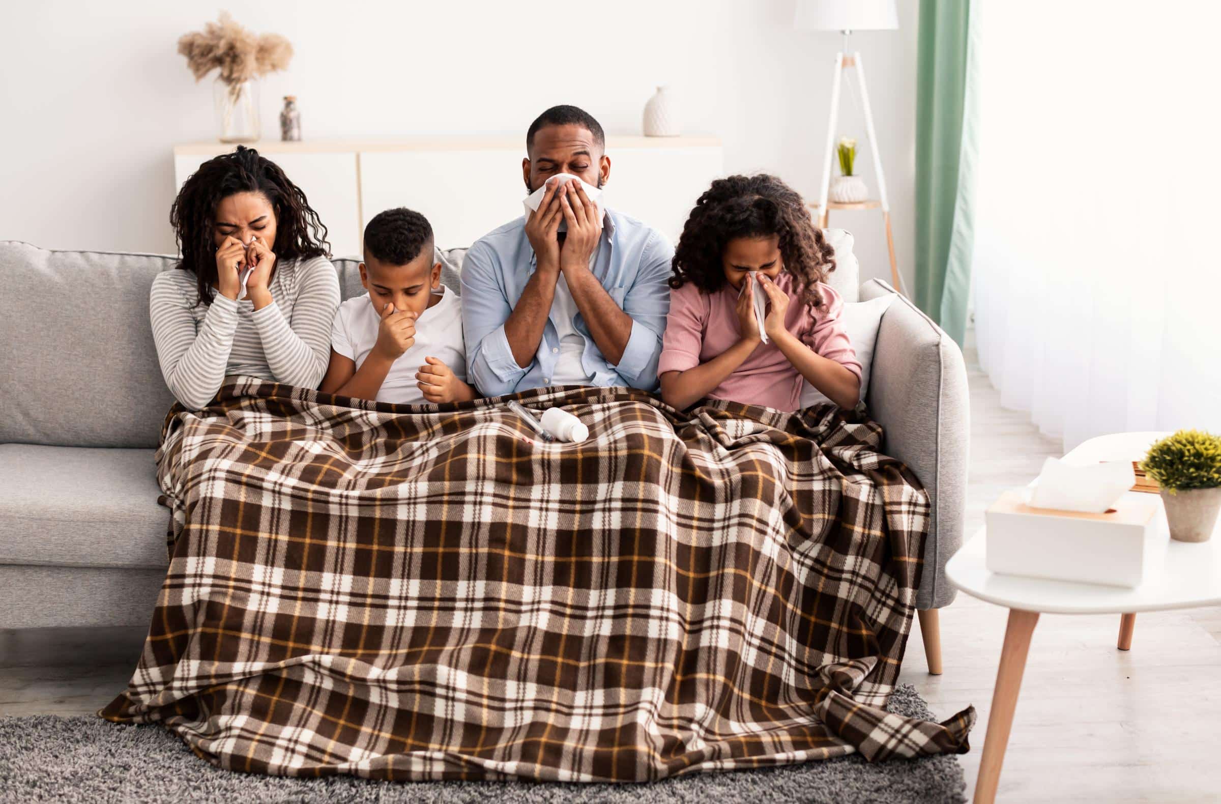 Family with cold on couch