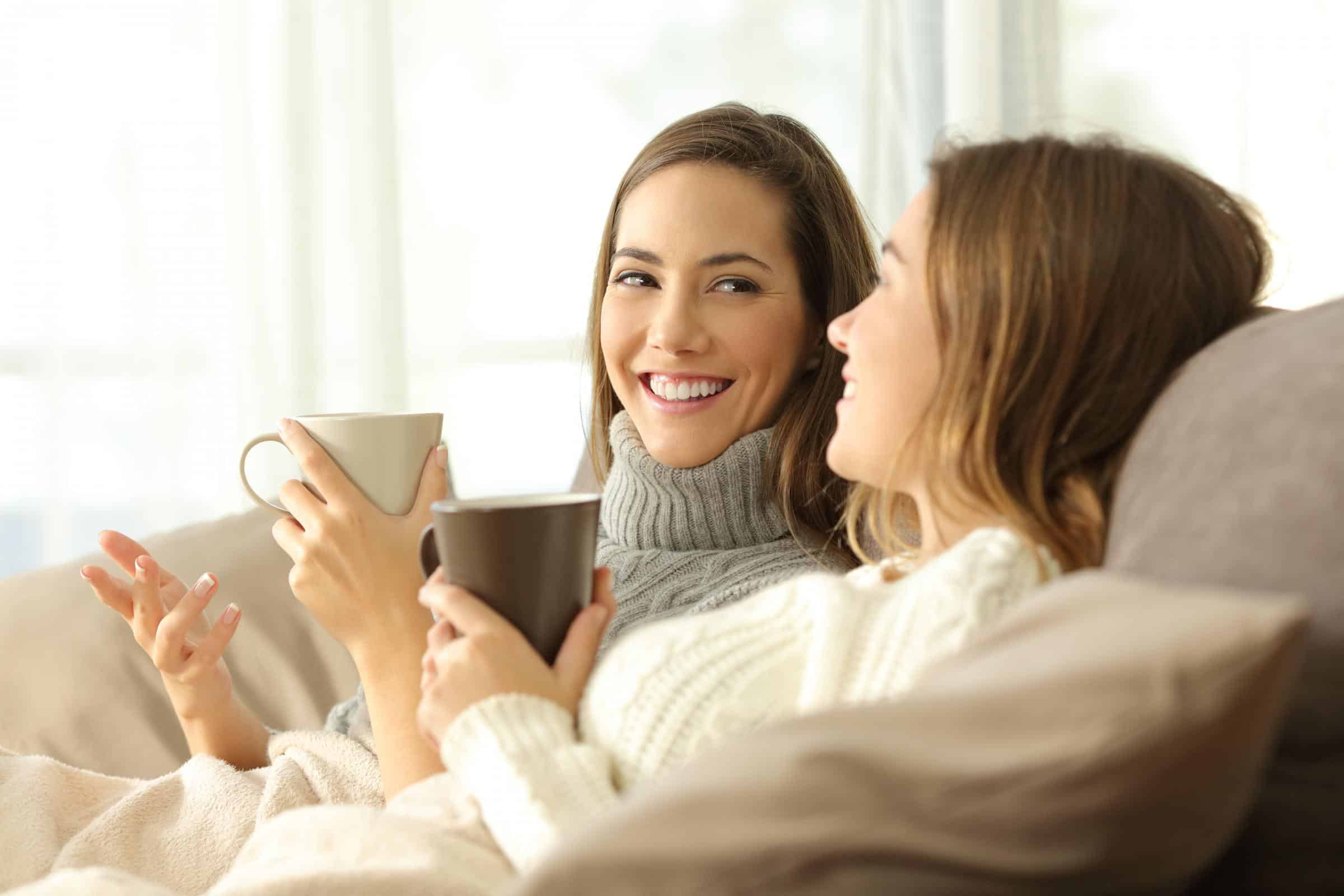 women talking on couch