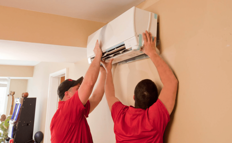 Technicians installing heat pump