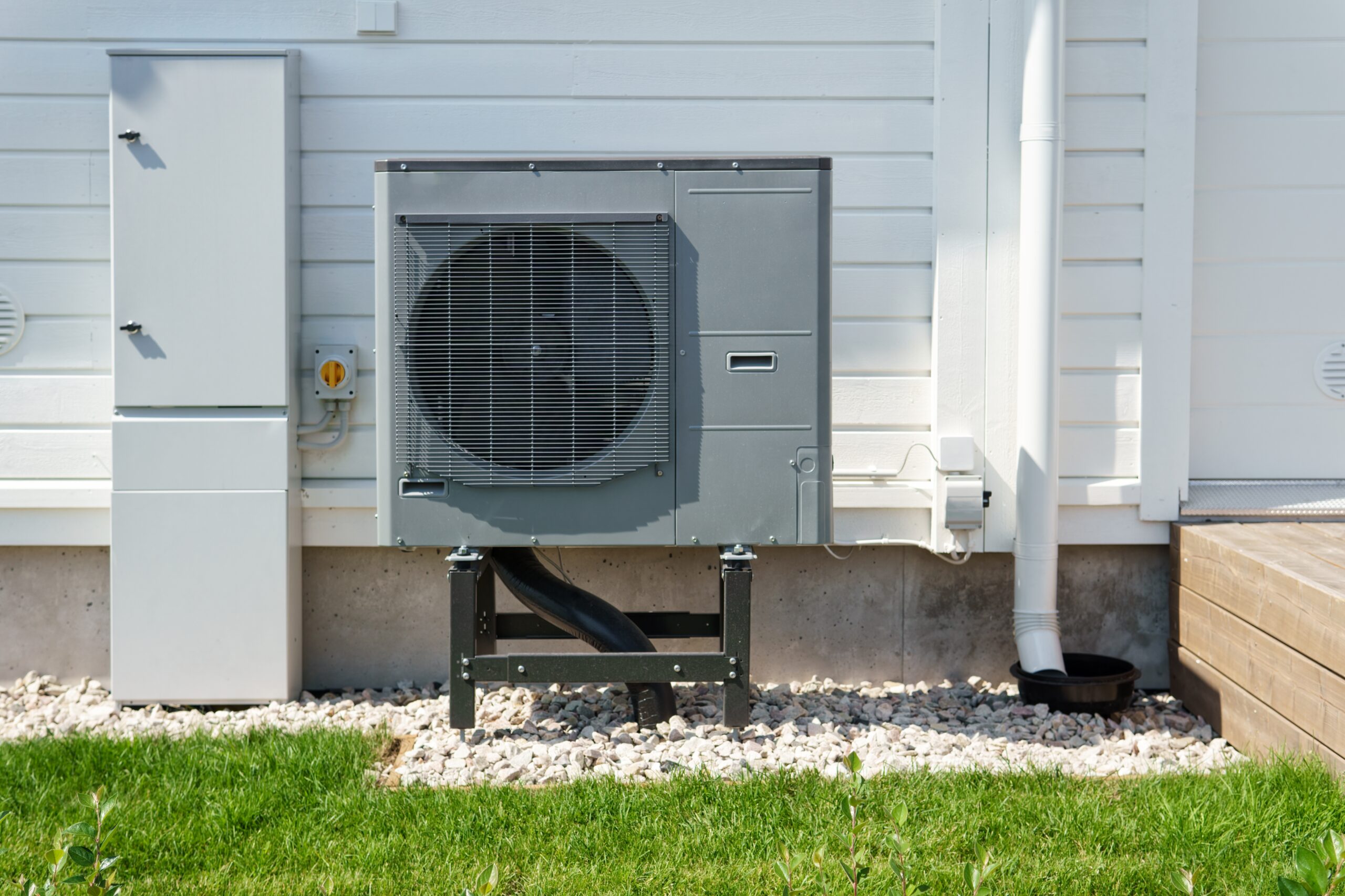 outdoor heat pump unit next to a modern home