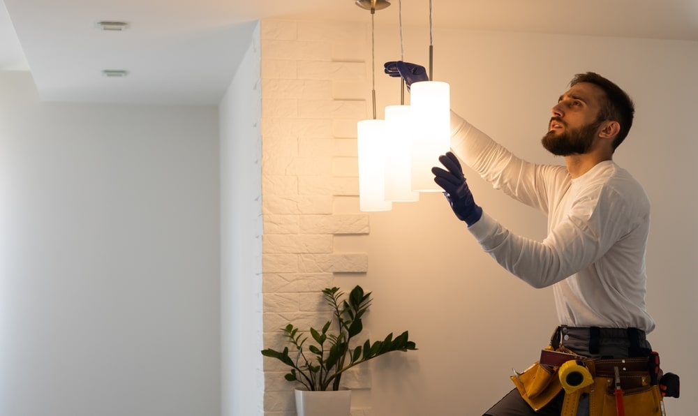 Electrician installing lights