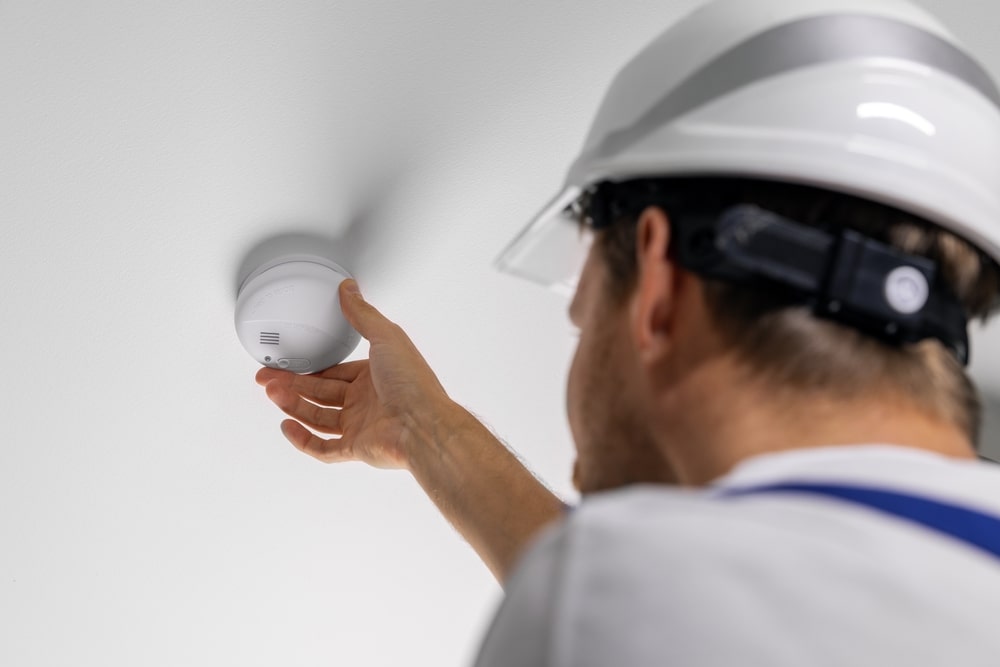 Technician installing carbon monoxide detector